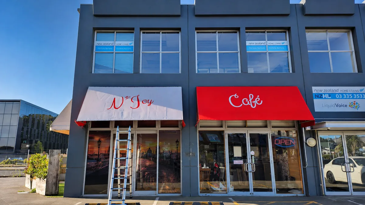 N’Joy Cafe’s red-and-white awnings and entrance on Lincoln Road