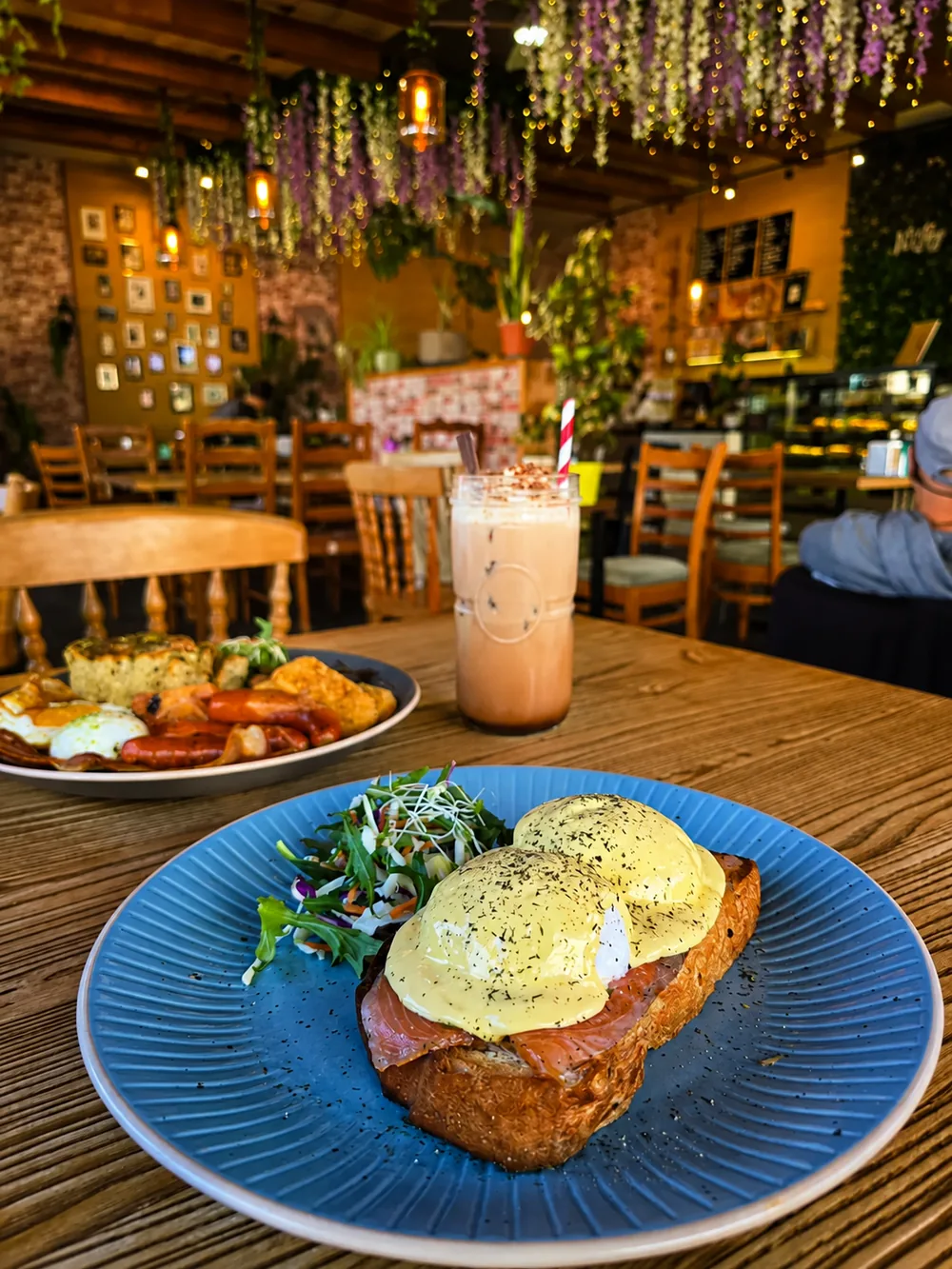 Eggs benedict on a blue plate at N’Joy Cafe